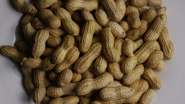 Cinematic, rotating shot of peanuts on a white surface - PEANUTS 017