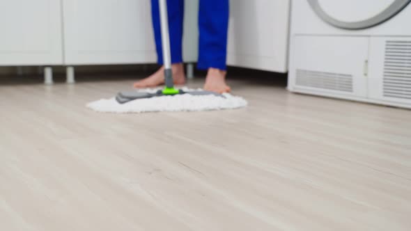 Close up of cleaning service woman worker cleaning in kitchen at home.