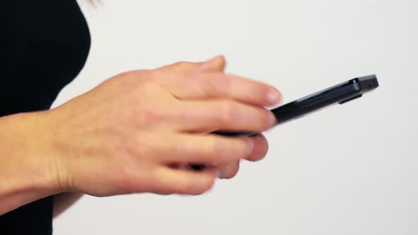 A Woman Works on a Smartphone - Closeup - White Screen Studio