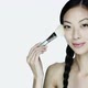 Young woman using make up brush on face - VideoHive Item for Sale