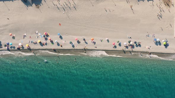 Vertical View of Beach Umbrellas by the Sea in Summer
