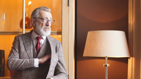 Toned Retro Styled Portrait of Businessman Sitting in Armchair at Office