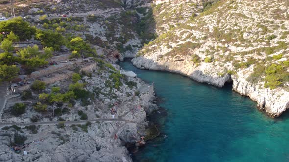 Aerial drone photo of iconic natural volcanic tropical fjord of Porto Limnionas with caves and cryst