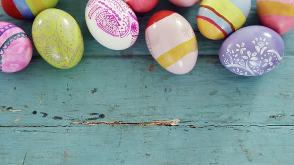 Painted Easter eggs on wooden surface