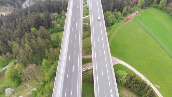 Aerial Top View of Highway Viaduct with Multilane Traffic in Mountains. Autobahn in Austria