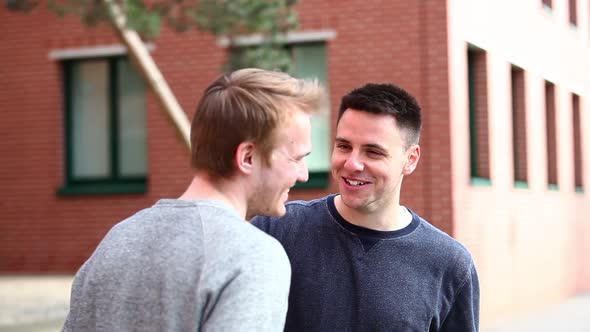 Two men talking and laughing together