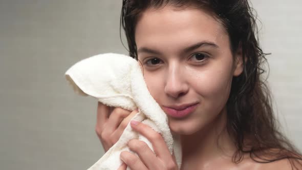 Woman Patting Face with Towel