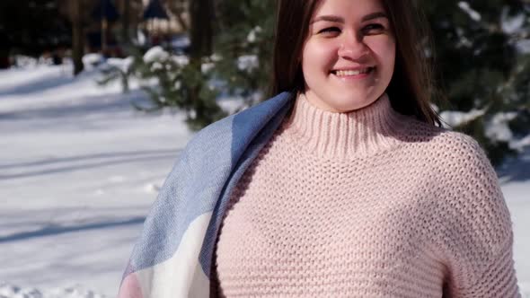 Beautiful Young Woman in Knitted Sweater in Winter Park