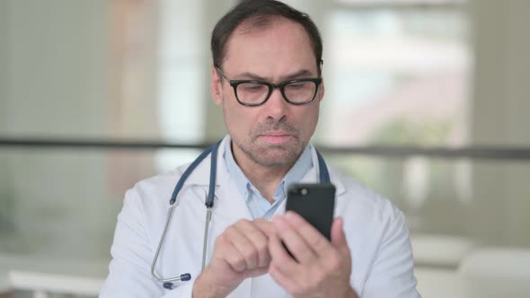 Middle Aged Doctor Using Smartphone