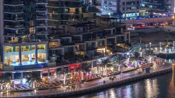 Luxury Dubai Marina Canal with Passing Boats and Promenade Night Timelapse Dubai United Arab