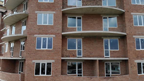 Aerial Construction of a Brick House. Installation of Wooden Roof