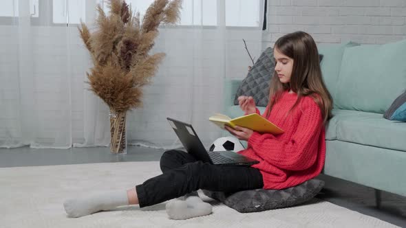 Beautiful Girl Making Notes of Online Lecture Lesson Sitting on the Floor Carpet