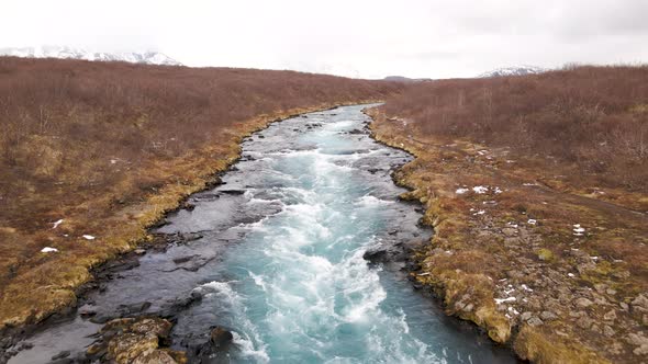 Wild ice cold river in South West Iceland - aerial drone shot