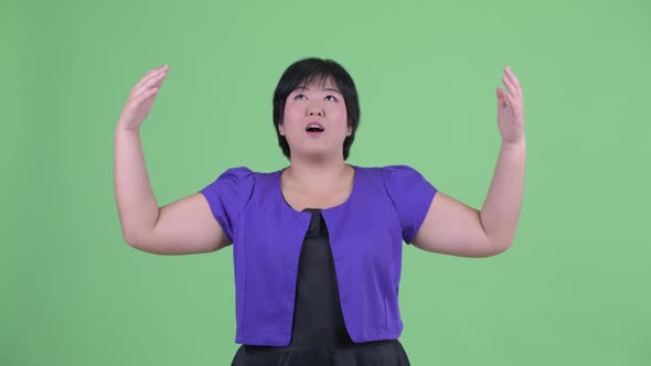 Happy Young Overweight Asian Woman Catching Something