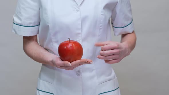 Nutritionist Doctor Healthy Lifestyle Concept - Holding Organic Red Apple