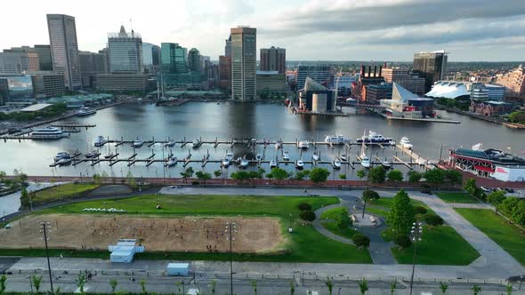 Aerial truck shot of Baltimore Inner Harbor from Federal Hill. Marina and boats at golden hour.