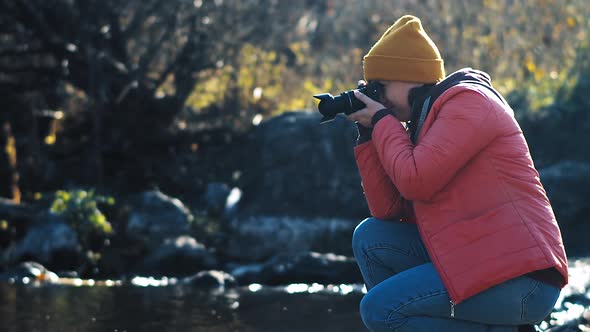 Woman Takes Picture of Stream Rapids