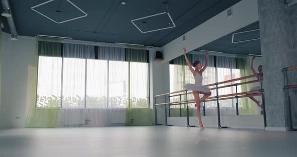 Girl in Tutu Dances Ballet in Studio