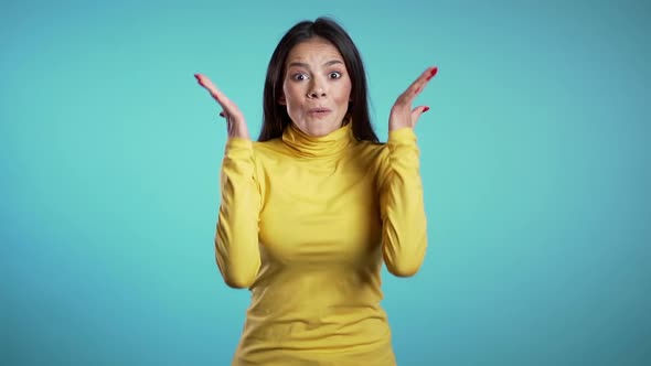 Portrait of cute mixed race girl shocked, saying WOW. Pretty latin woman smiling, jumping