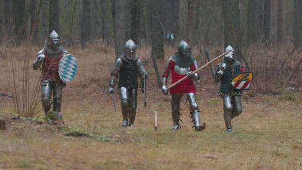 Four Men Knightes Walking in the Row in the Forest in Full Armour