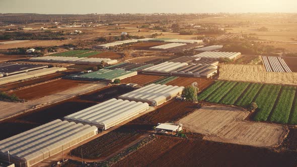 Greenhouses Buildings and Soil Fields on Rural Farm