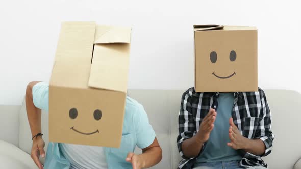 Silly employees with boxes on their heads doing the robot