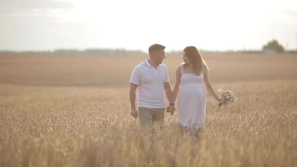 A Loving Couple Walking in the Field of Gold Rye.