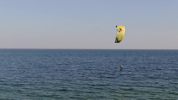 Aerial view of a man kitesurfing on the sea
