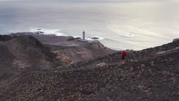 Aerial Footage of a Man Jogging By Underground Volcanic Center