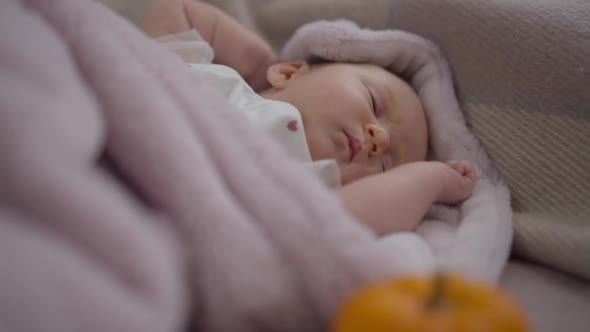 Newborn Caucasian Girl Falling Asleep Lying in Comfortable Bedroom at Home Indoors