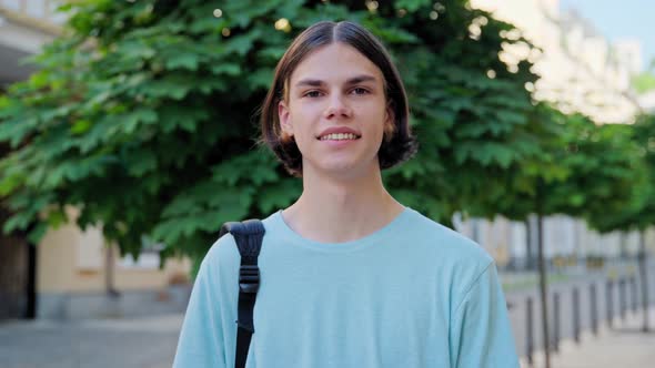 Smiling Teenage Male Student Looking at Camera Outdoor