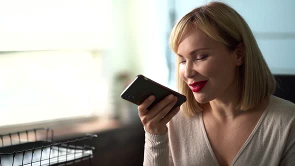 Woman Is Recording Voice Message at Smartphone and Sending, Modern Technology