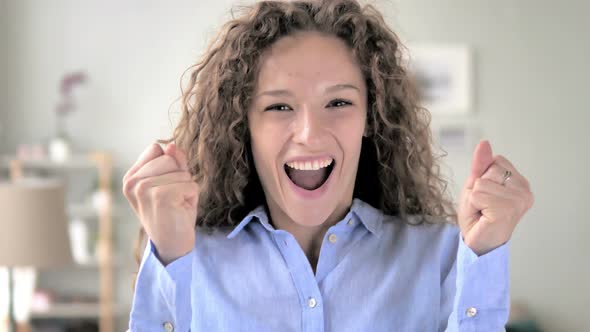 Curly Hair Woman Celebrating Success  Gesture in Office