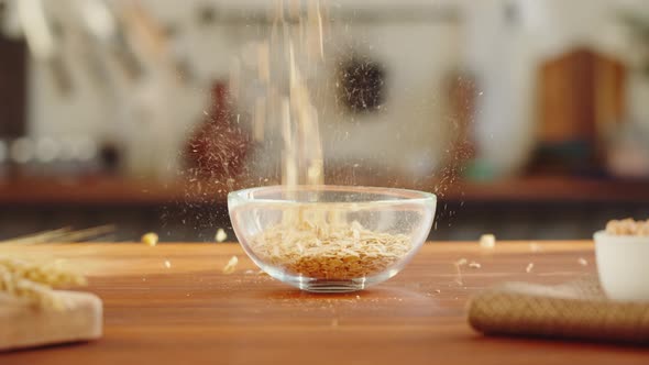 Grocery Putting Cornflakes in Bowl Closeup