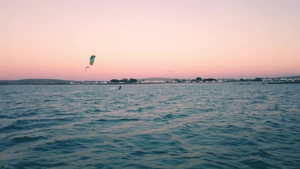 ultra wide drone shot following kite surfers on scenic sunset on Langebaan Beach, Cape Town, South a