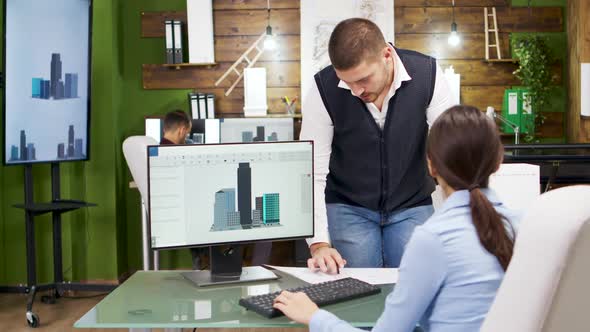 Construction Engineer and Female Architect Having a Discussion About New Office Buildings