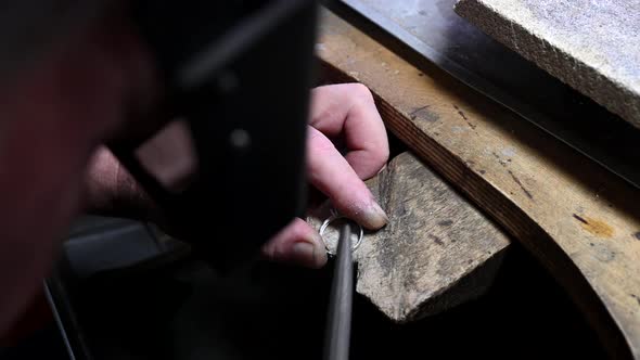 Closeup of Wedding Ring Polishing By Caicasian Jeweler Isolated  Footage