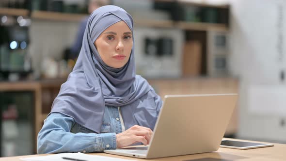 Beautiful Arab Woman with Laptop Looking at the Camera 