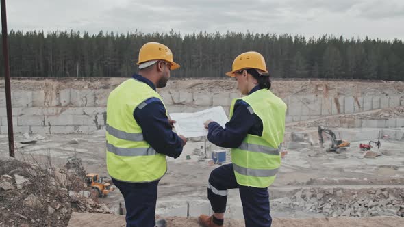 Workers Discussing Quarry Blueprint