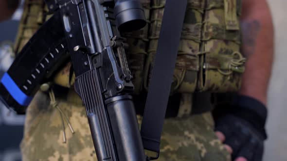 Closeup of a Ukrainian Soldier in Military Uniform with Elements and Insignia of the Ukrainian Army