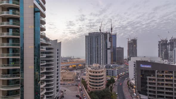 Dubai Marina Skyscrapers Port with Luxury Yachts and Marina Promenade Aerial Day to Night Timelapse