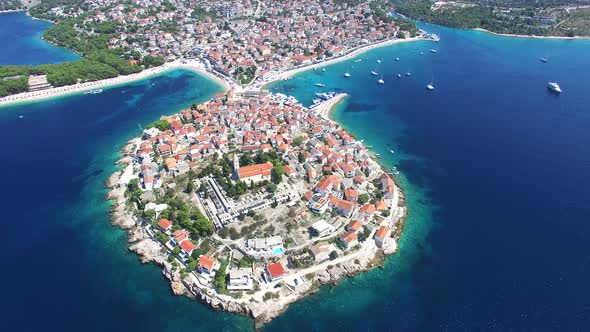 Flying above traditional dalmatian houses on Primosten peninsula, Croatia