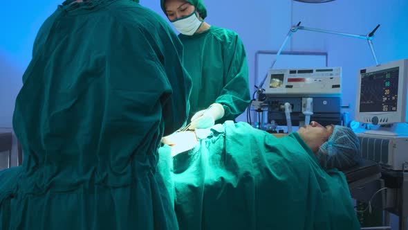 asian coworker Medical Team Performing Surgical  performing an operation