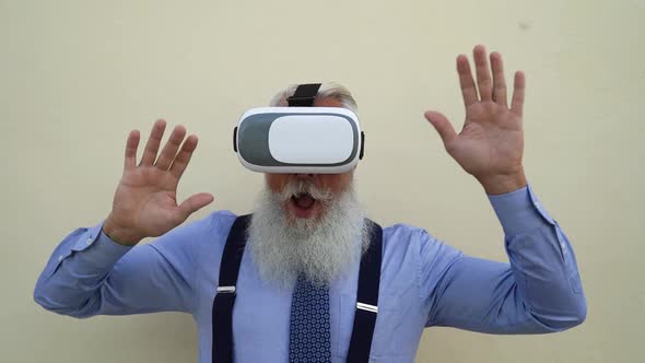 Senior fashion male playing with virtual reality glasses outdoor