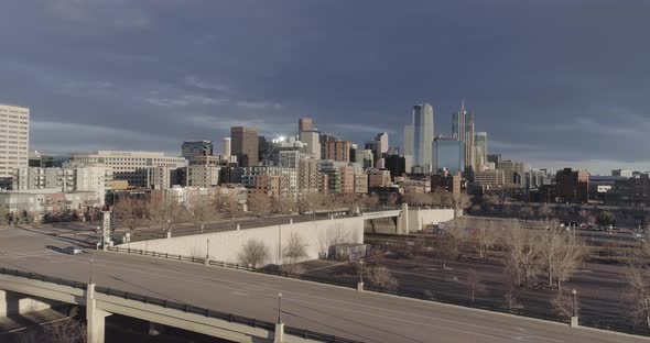 Planing left with traffic visible on Speer Blvd. Denver cityscape and skyline Jan17 2021.