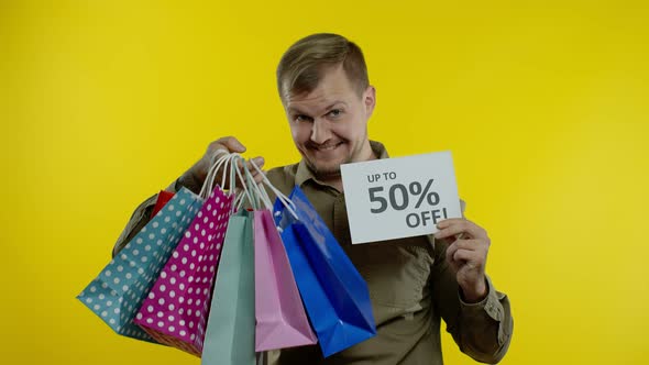 Man Showing Up To 50 Percent Off Inscription and Shopping Bags, Rejoicing Discounts. Black Friday