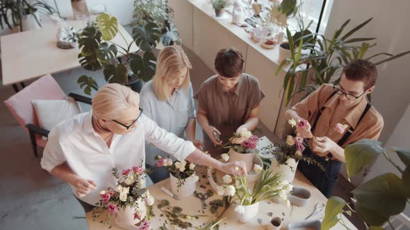 Three Women and Male Florist Making Bouquets on Masterclass in Flower Shop