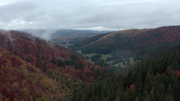 Mountain Ranges With Thicket Autumn Colors In Romania During Hazy Morning. - Aerial Shot