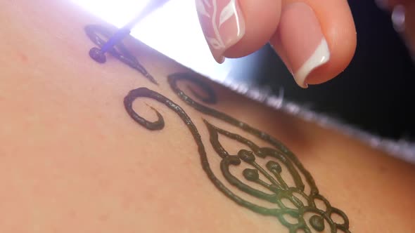 Process of Applying Mehendi on Female Back, on Black, Light