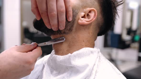 A Man Client Visiting Haidresser In Barber Shop, Beard Trimming